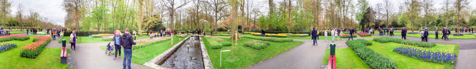 KEUKENHOF; THE NETHERLANDS - APRIL 2015: Tourists visit Keukenhof gardens in spring. This is a...