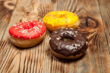 Various decorated doughnuts in motion falling on blue background. Sweet and colourful doughnuts falling or flying in motion.