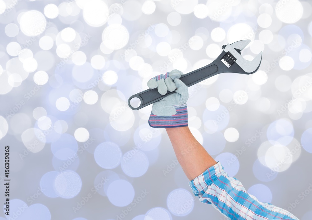 Poster hand with wrench and sparkling light bokeh background