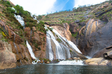 Waterfall View Amidst Cliff Rocks and Sky