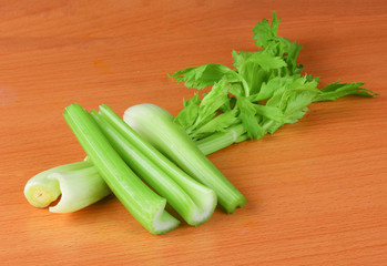 Fresh celery isolated on wooden background