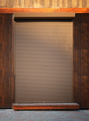 Wooden building with automatic blinds on entrance door