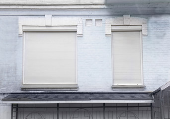 Windows with closed blinds on old building