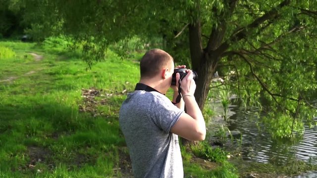 the operator takes photos of nature on camera.