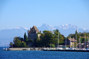 The beautiful medieval garden town of Yvoire, France on Lac Leman with Chateau d'Yvoire and the Alps as the background