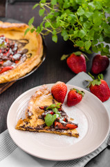 Pancake in oven, dutch baby pancake with strawberries