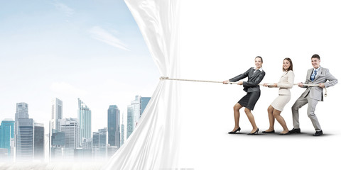 Young businesspeople working in collaboration and pulling white advertisement banner