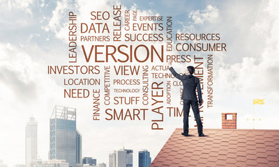 Young businessman standing on house roof and writing leadership 