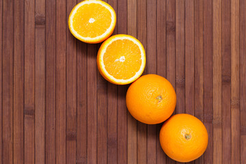 Fresh orange fruits isolated on wooden background. Healthy food. A mix of fresh fruit. Group of citrus fruits. Vegetarian raw fruit. Nutrition for a healthy lifestyle.
