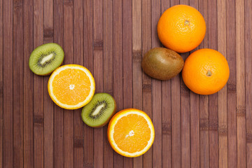 Fresh fruits kiwi, orange isolated on wooden background. Healthy food. A mix of fresh fruit. Group of citrus fruits. Vegetarian raw fruit. Nutrition for a healthy lifestyle.