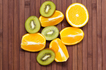 Fresh fruits kiwi, orange isolated on wooden background. Healthy food. A mix of fresh fruit. Group of citrus fruits. Vegetarian raw fruit. Nutrition for a healthy lifestyle.