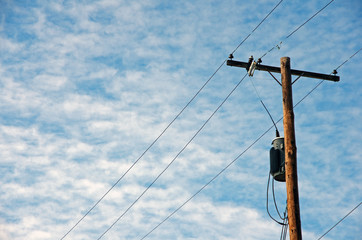 Electricity tower and blue sky with stratus clouds