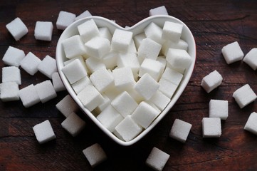 White sugar cubes  on wooden background
