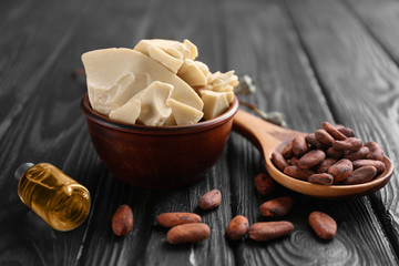 Composition with cocoa butter and beans on wooden background