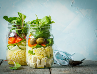 Colorful salad with couscous, tofu and vegetables in a jar. Love for a healthy vegan food concept