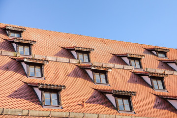 Tiled roof with mansard windows of attic rooms