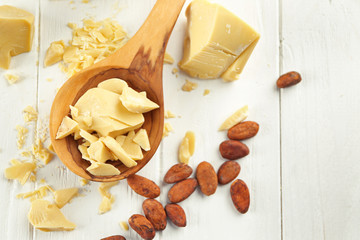 Composition with cocoa butter and beans on wooden background
