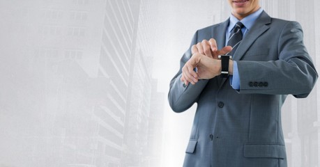 Businessman holding watch with bright city background