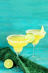 Lemon Margarita cocktails with limes and copyspace