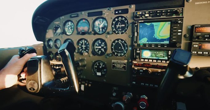 POV cockpit view of small plane instruments and flight controls