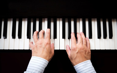 Man hands playing piano. Classical music. Art and abstract background.