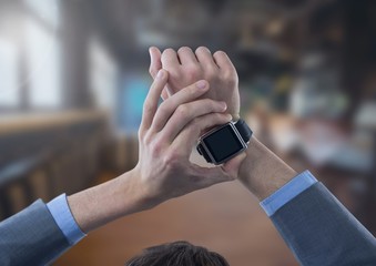 Businessman holding watch in large room