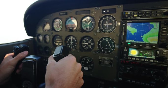 Detail shot of airline pilot flying small plane holding controls in hands