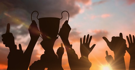business hands with trophy shade and more hand shades. sunset