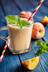 Healthy peach milkshake in a glass jar