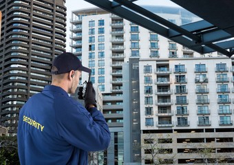 security guard speaking with walkie-talkie. City