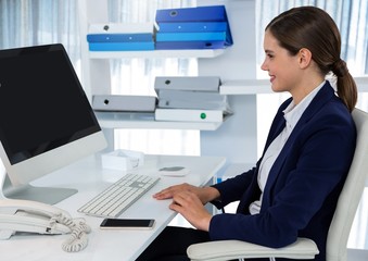 Obraz na płótnie Canvas Businesswoman on computer at desk