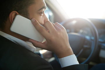 Businessman using phone in a car