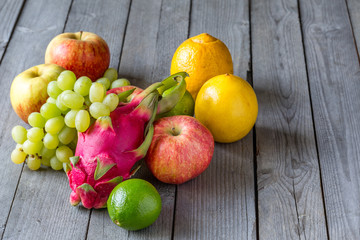 Exotic and traditional fruits on a old wooden table