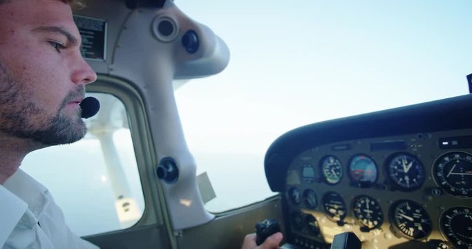 Pilot Flying Small Airplane at Sunrise. POV Cockpit View
