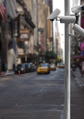 cctv stick in the road, taxi behind it