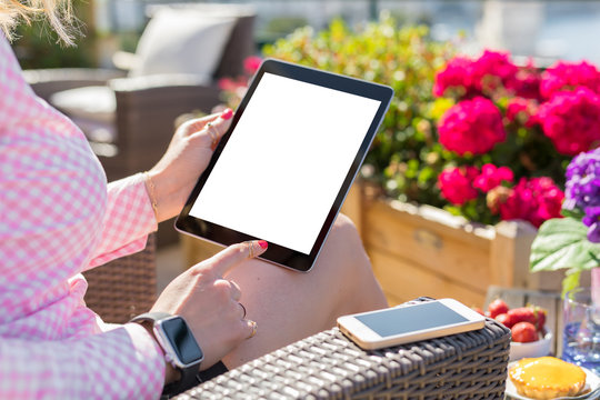 Woman using tablet with blank white screen