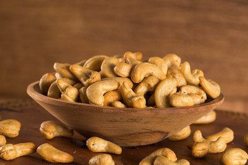 Roasted cashew nuts on wooden background