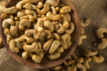 Cashew nuts in wood bowl on wood background