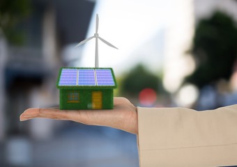 solar panel house and windmill on hand  in the city