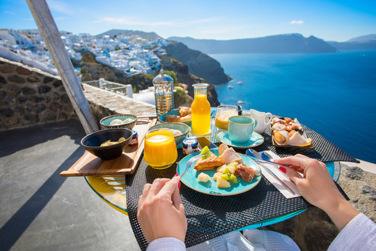 Woman having breakfast in Santorini, Greece