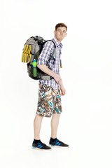 Young hiker with backpack on white background