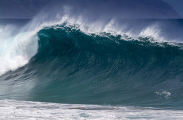 Big breaking Ocean wave barrel on the north shore of Oahu Hawaii