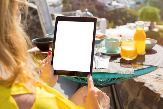 Woman using tablet computer while having breakfast - Powered by Adobe