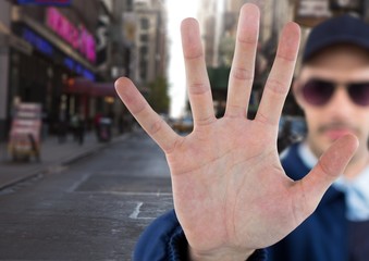 Man with stop hand gesture on street