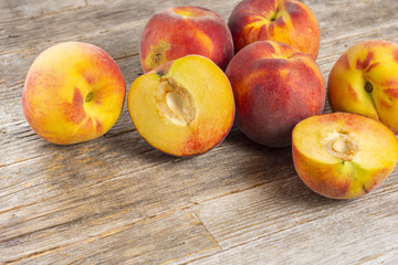 Fototapeta na wymiar Sliced peaches on wooden floor