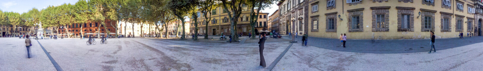 LUCCA, ITALY - OCTOBER 2015: Tourists along Napoleon Square. Lucca attracts 2 million tourists annually