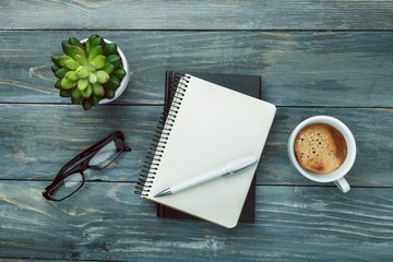 Notebook with glasses and coffee.