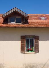 Fragment of vintage facade with window and roof. Tel Aviv, Israel.