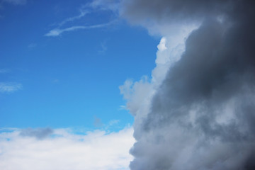 Fototapeta na wymiar Huge white cumulus clouds against blue sky in spring.