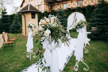 Wedding decoration ceremony outdoor, beautiful white arch with fresh flowers